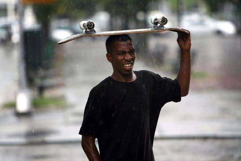 person holding 22 inch skateboard