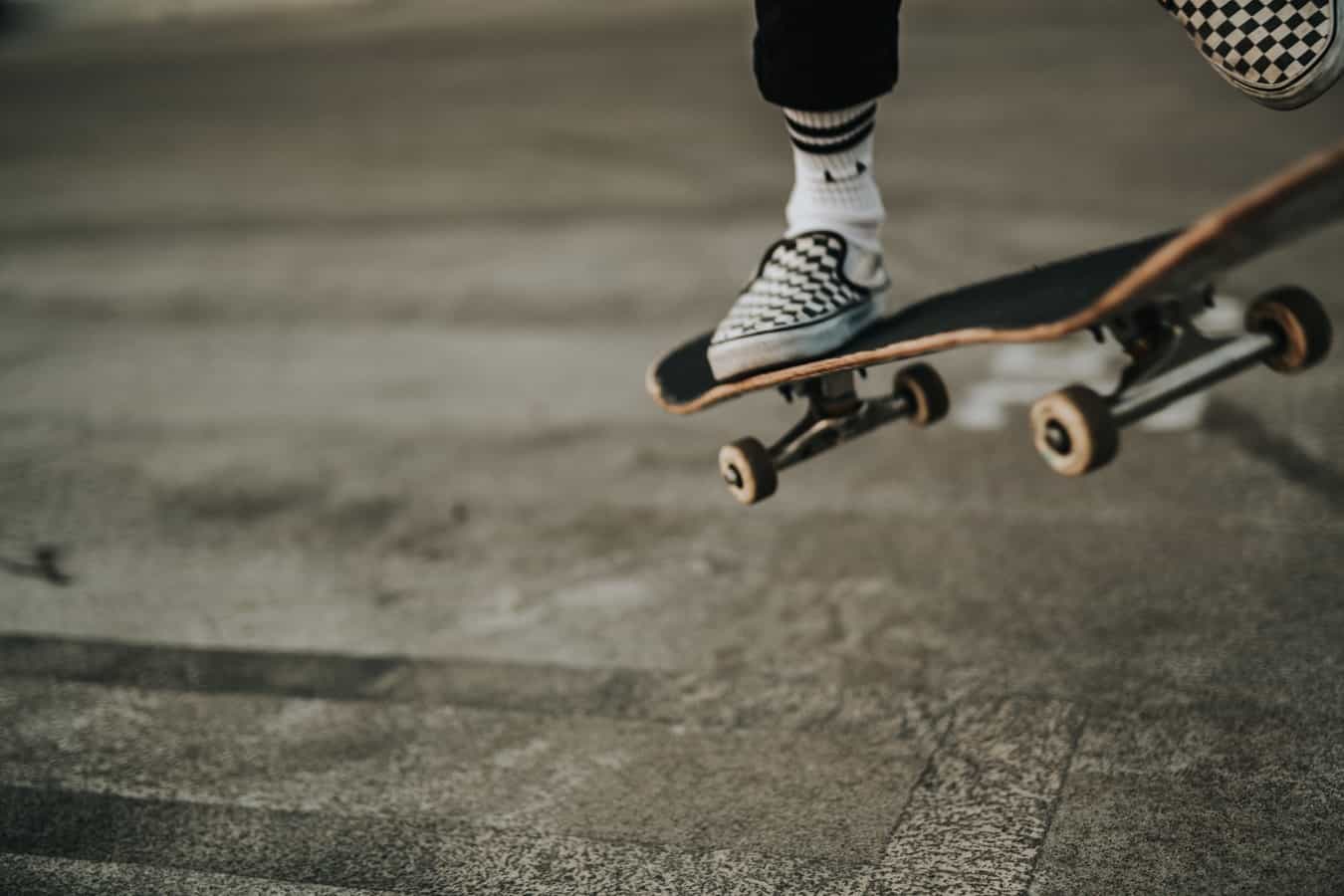 person wearing skate shoes on skateboard